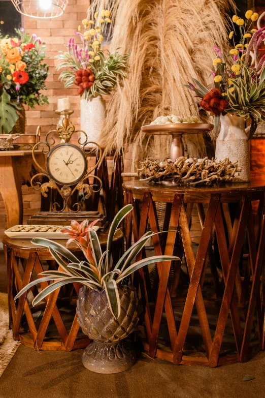 two tables holding assorted plants and a clock