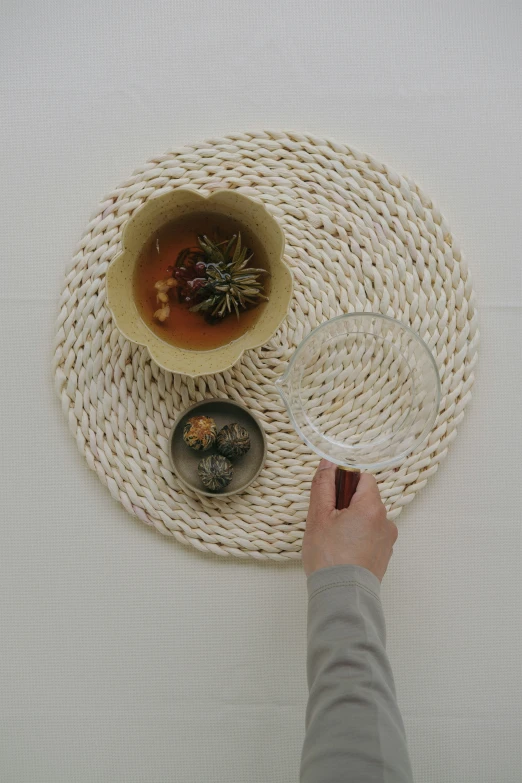 a person holding a wine glass and serving dish on a tray