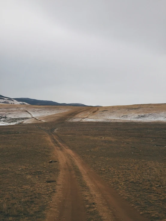 a dirt road in the desert with no traffic