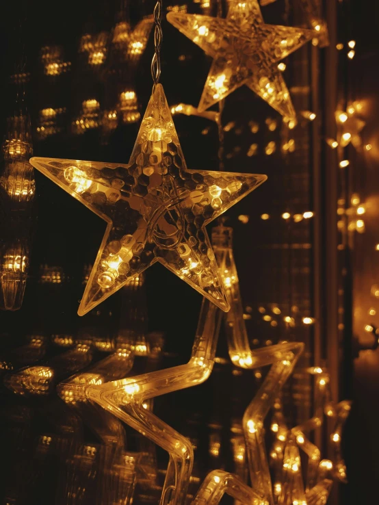 several lighted stars are on display with lights