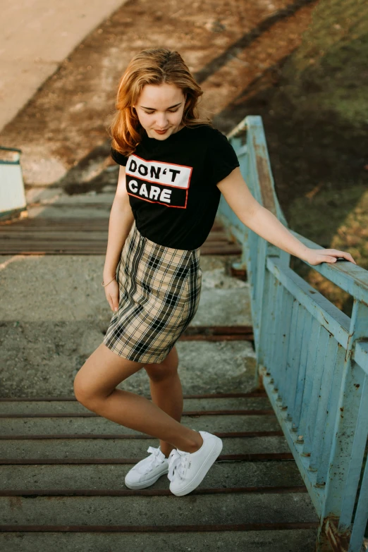 young woman with short shorts and shirt walking up steps