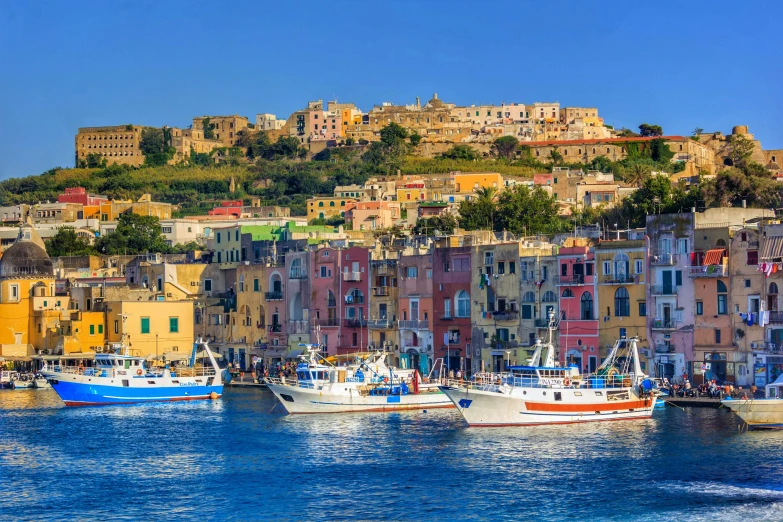 boats parked in the water near several houses