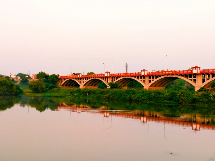 a bridge is on the water with a building in the background