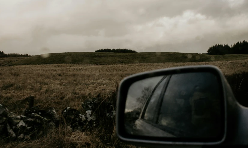 a view out of a car window shows clouds in the distance