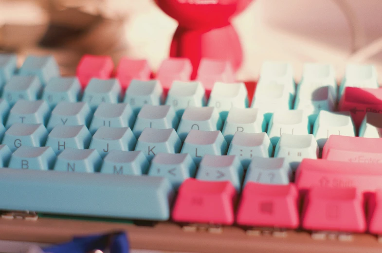 there is a pink and blue computer keyboard