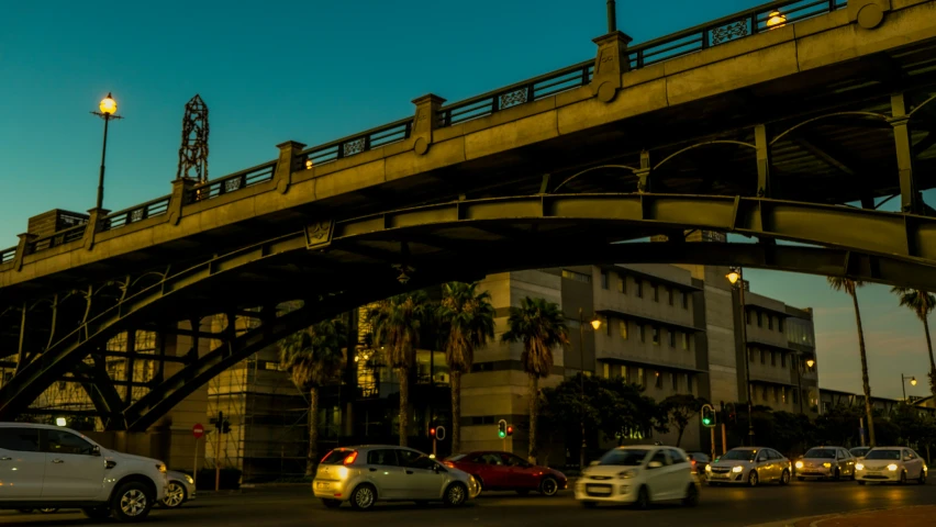 a bridge spanning over a street in front of a building