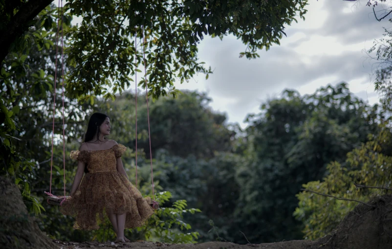 a woman dressed as a princess in the woods