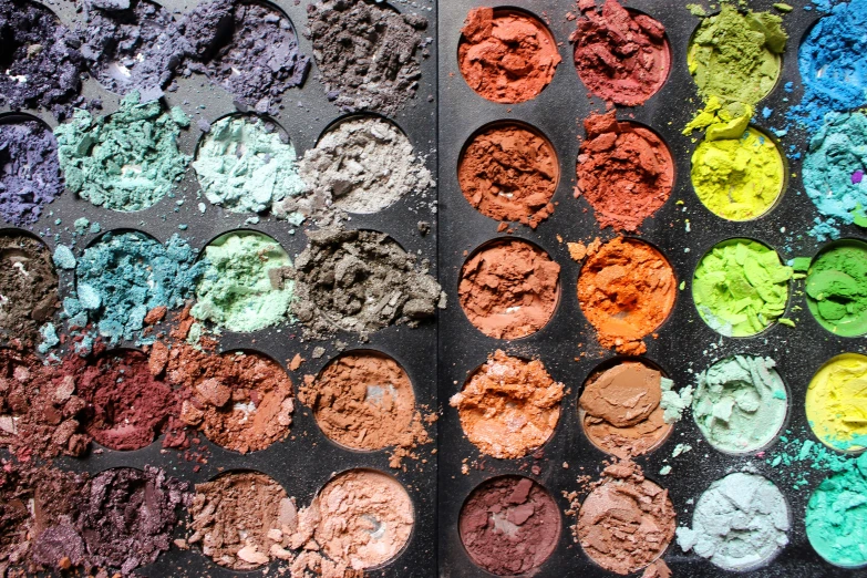 many colorful powdered powders are spread out in bowls
