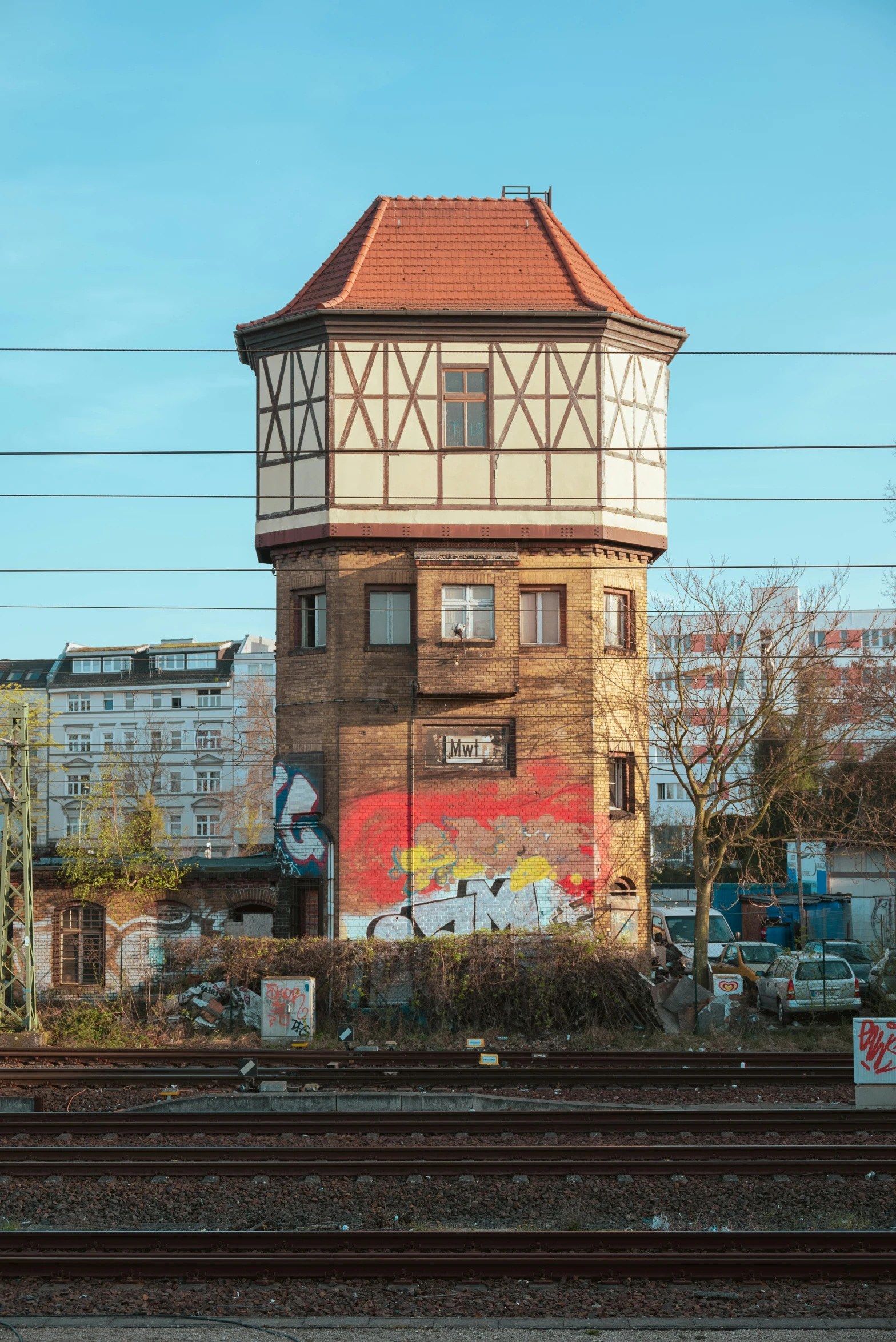 a building next to railroad tracks near a fence