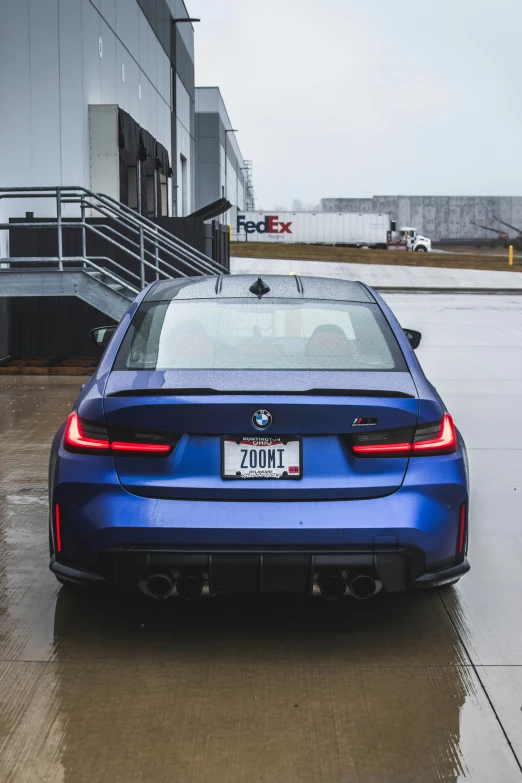 blue bmw car with no roof is on a wet road