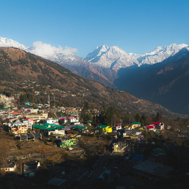 an image of a small town with mountains in the background