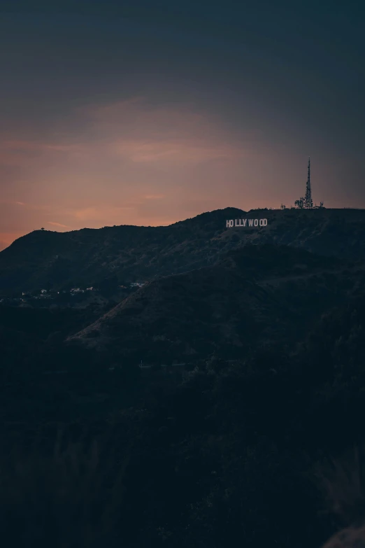 a hillside with a sign on the top