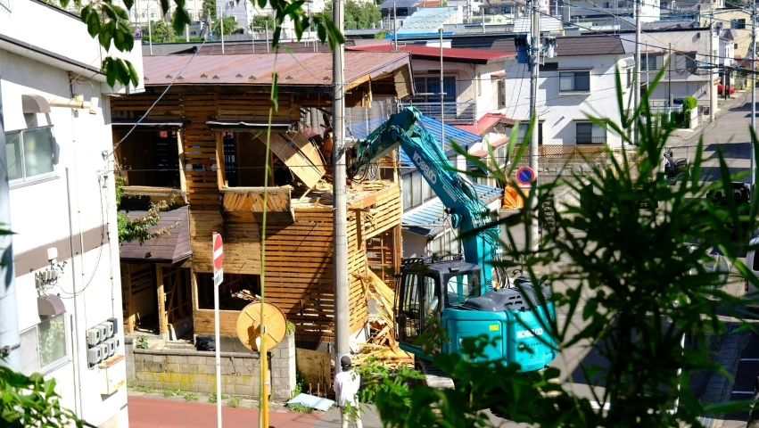 a crane sits in front of a house