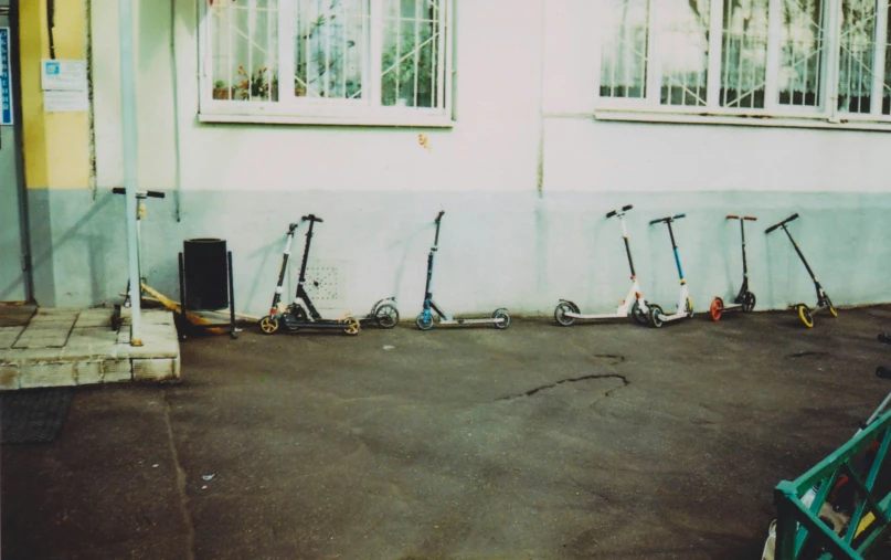 four scooters parked in front of a house