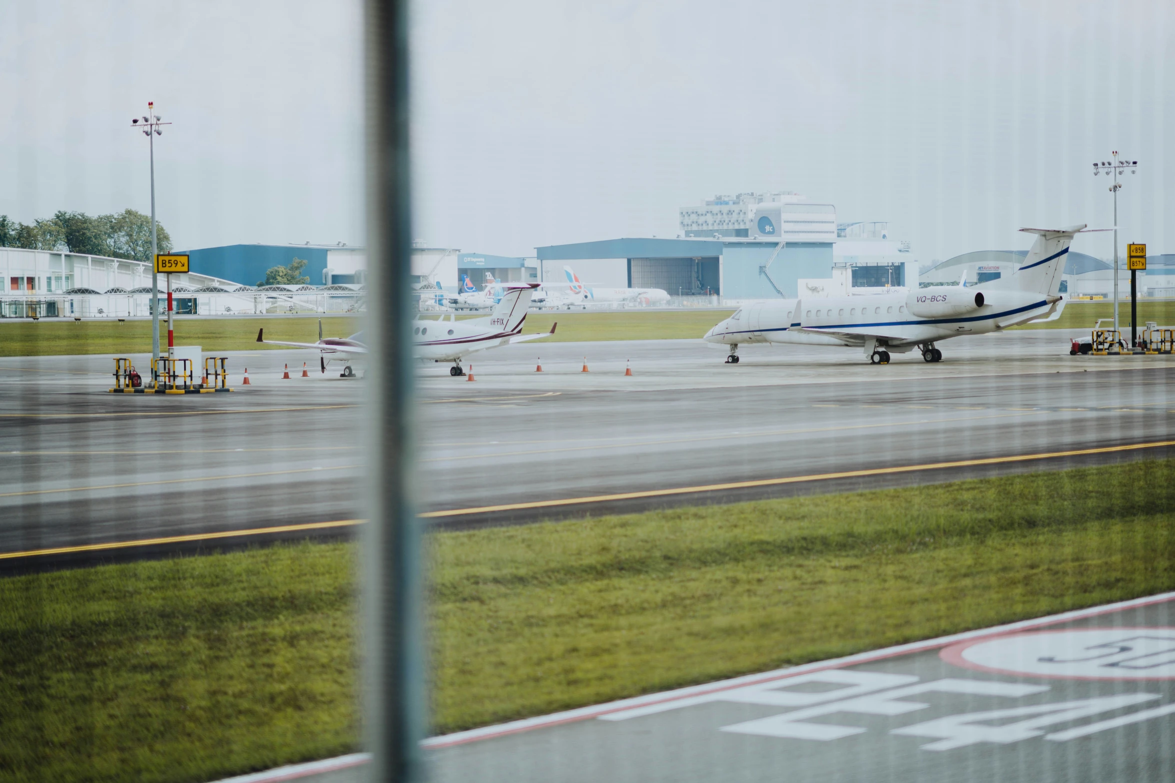 a white jet airliner sitting on top of an airport runway