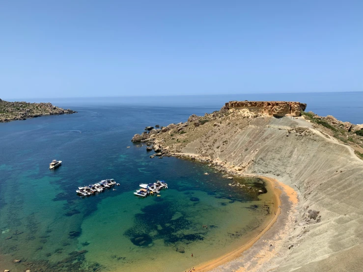 a beach with boats in the water