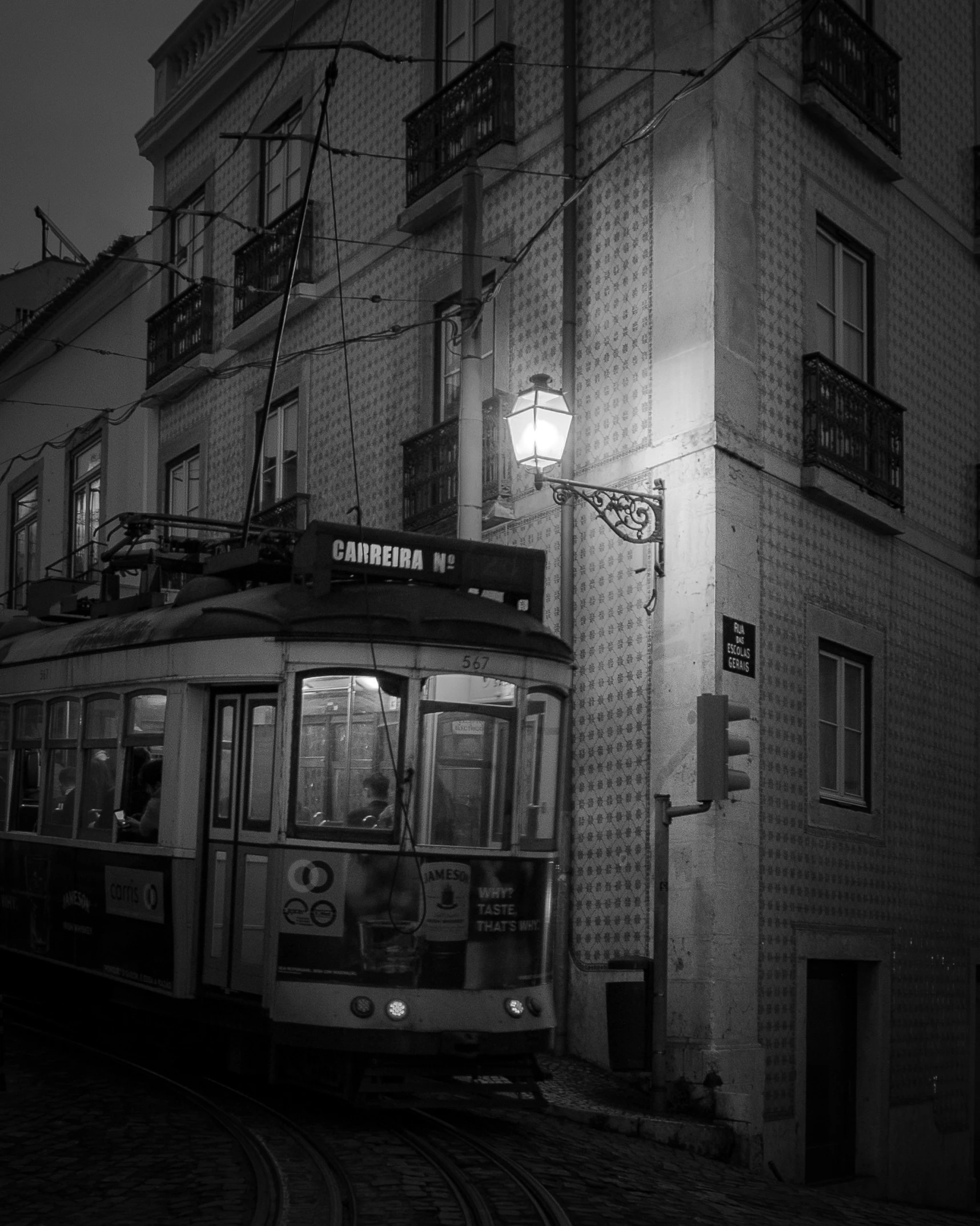 a street car is traveling down the street at night