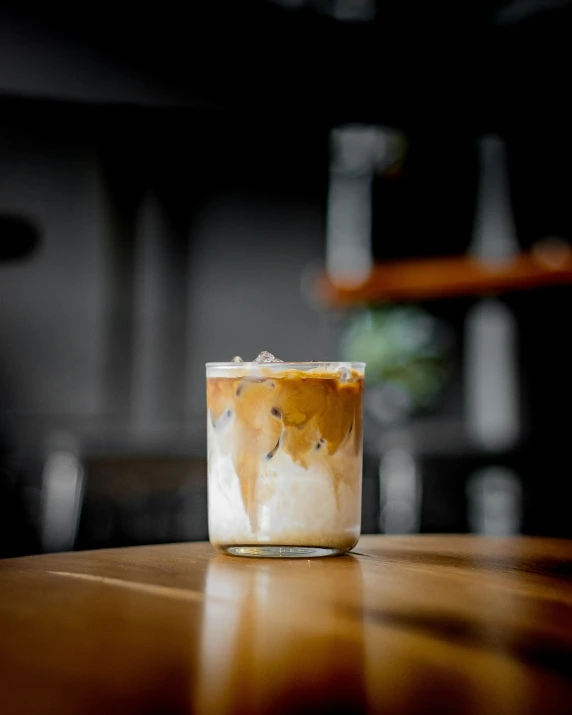 a cup with drinks on a wooden table