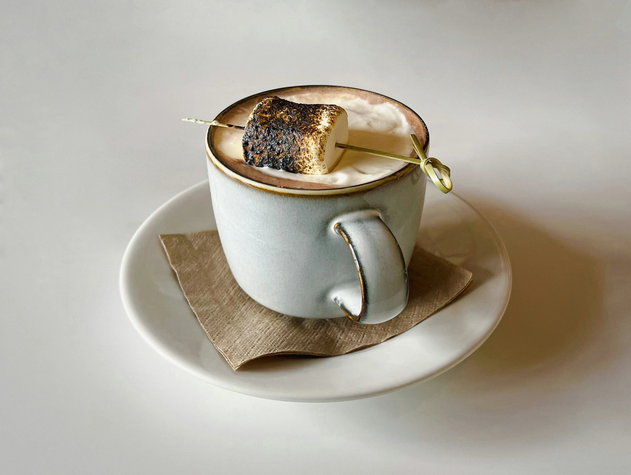 a cup of tea on a saucer and napkin