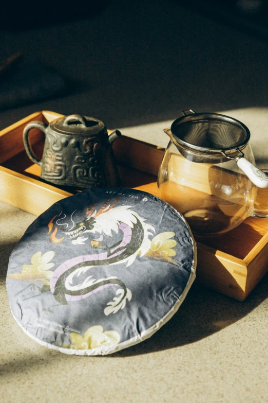 a dish, tea pot and other decorative items lay together