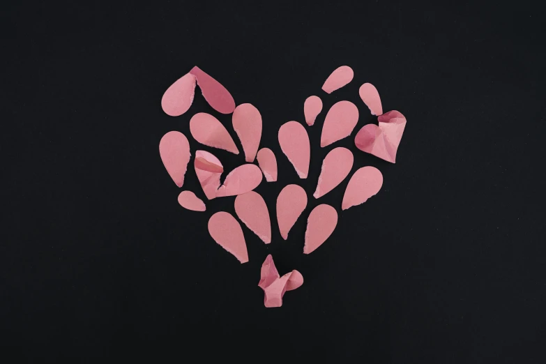 an artistic po of a heart made out of pieces of pink paper