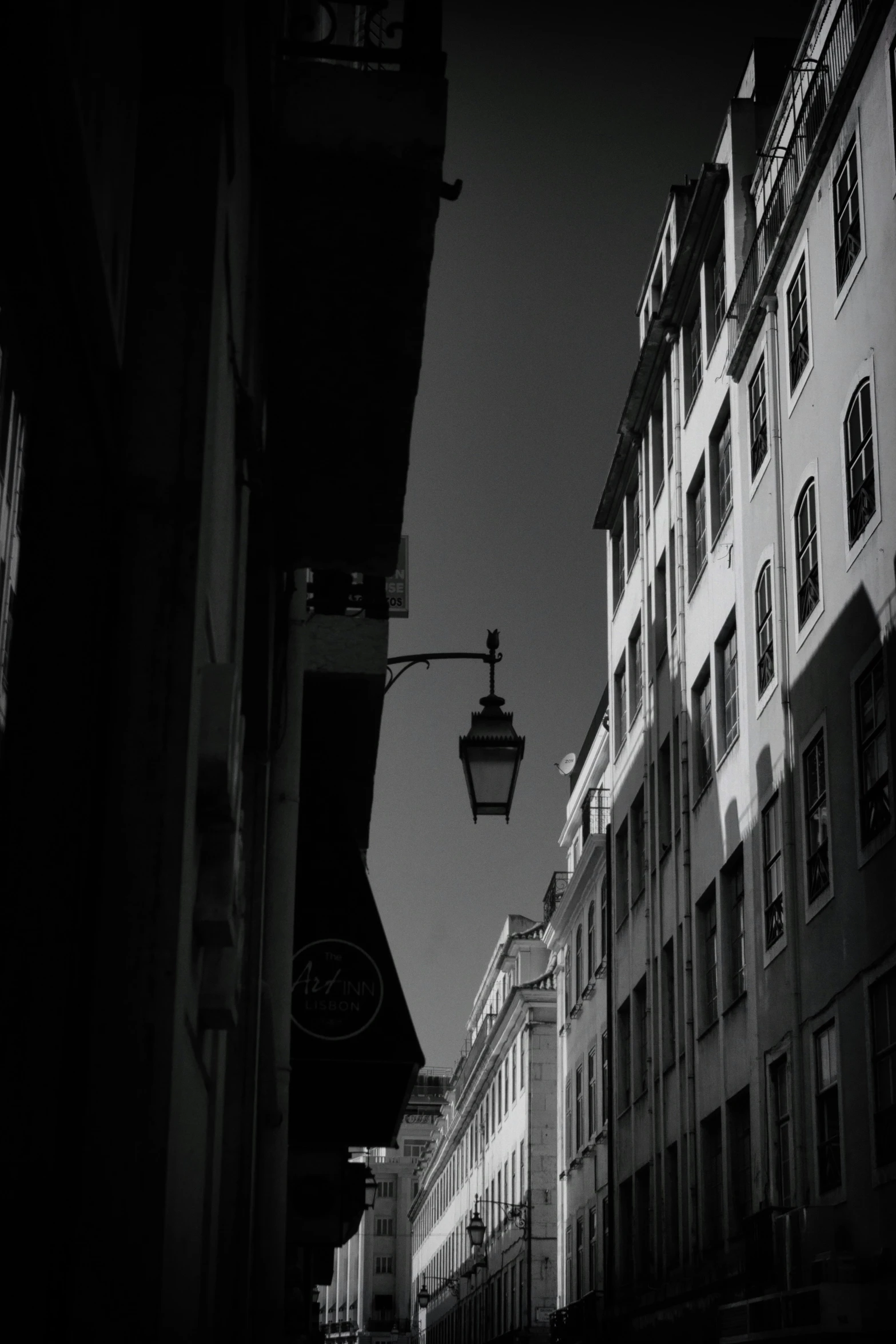 a black and white po of a city street with many buildings