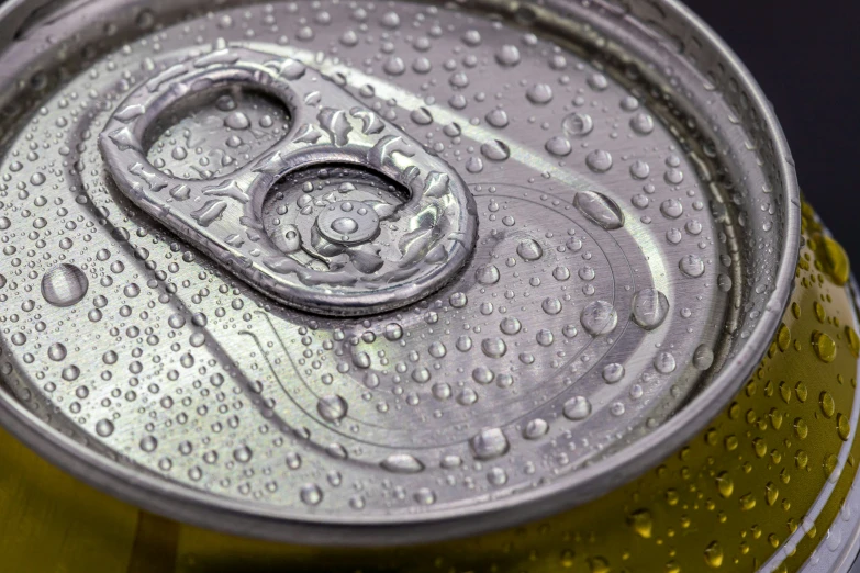 a can of soda has water droplets all over it
