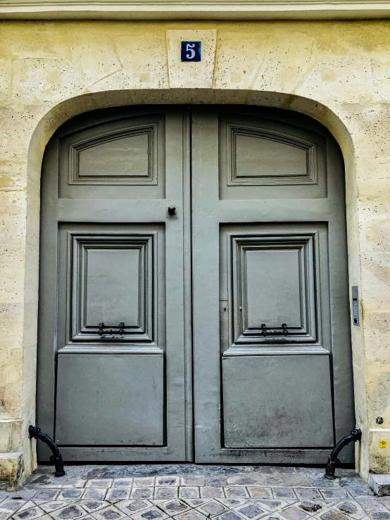 two doors that are open with a blue and black number