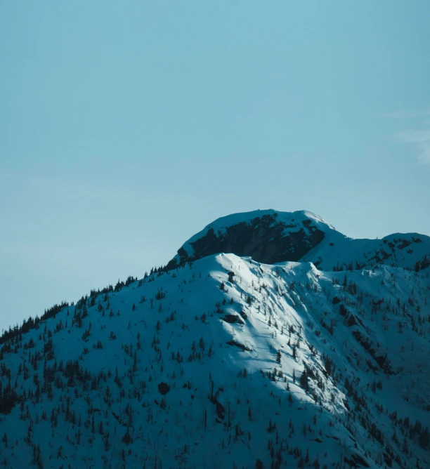 the lone snowboarder is in midair from the mountain