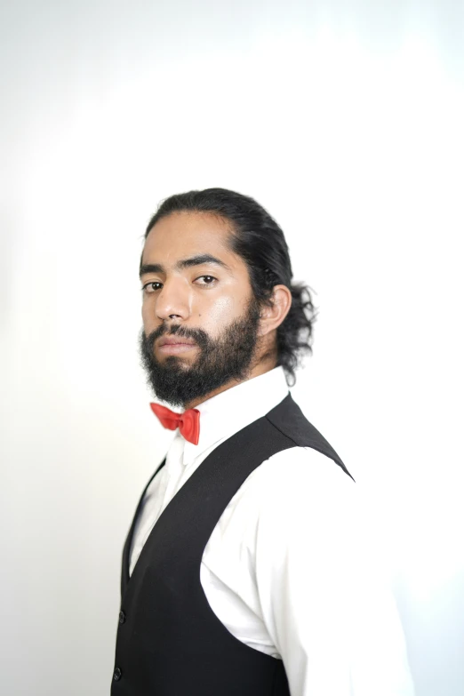 an indian male wearing a red bow tie