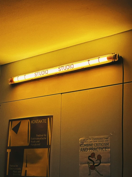 an elevator with signs and a neon sign above
