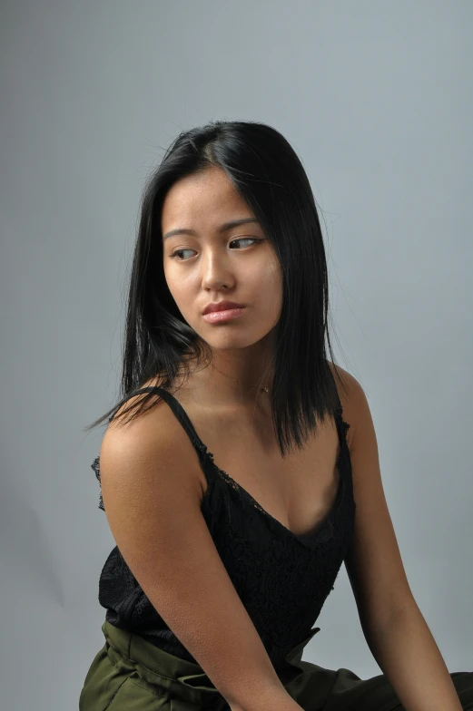a young asian woman wearing an all black outfit poses for the camera
