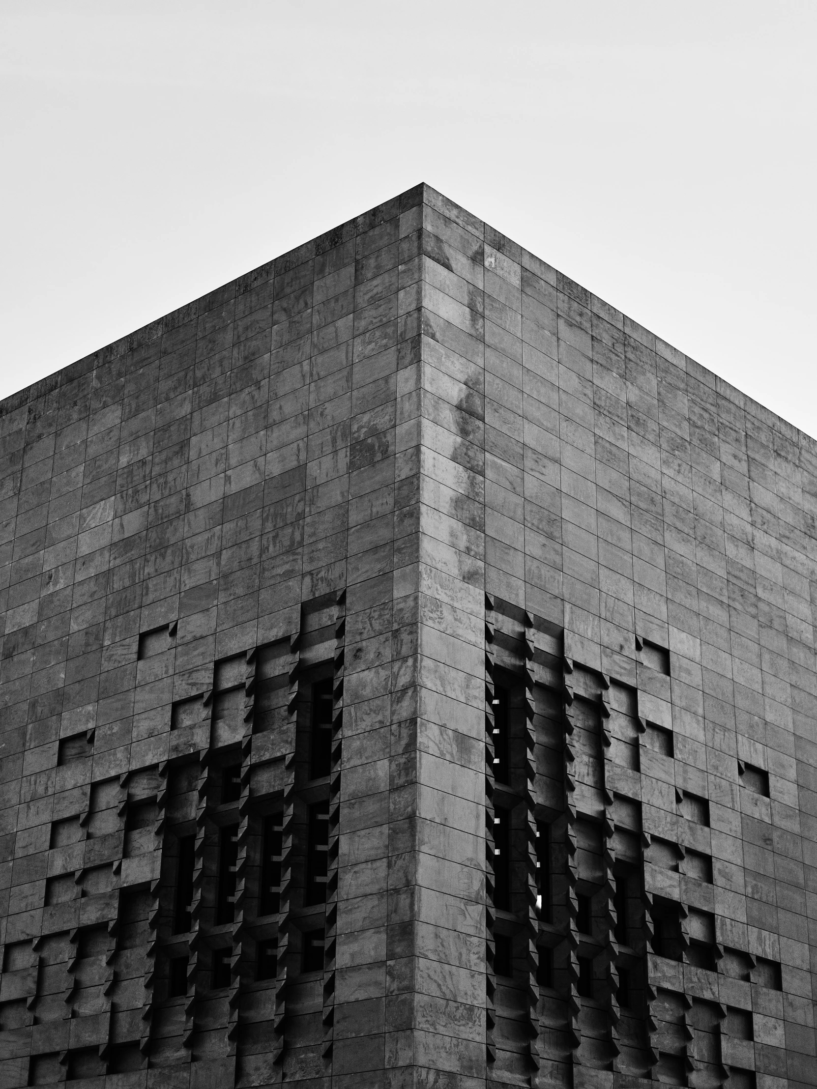 an airplane is flying above the side of a building