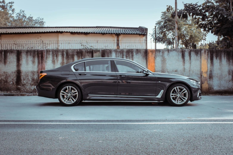 a black bmw parked in a parking lot