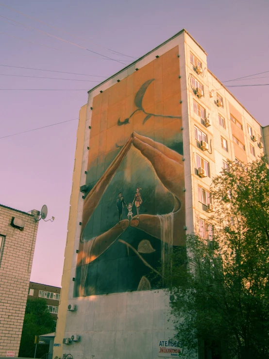 a building has been painted with an image of a person standing at the window