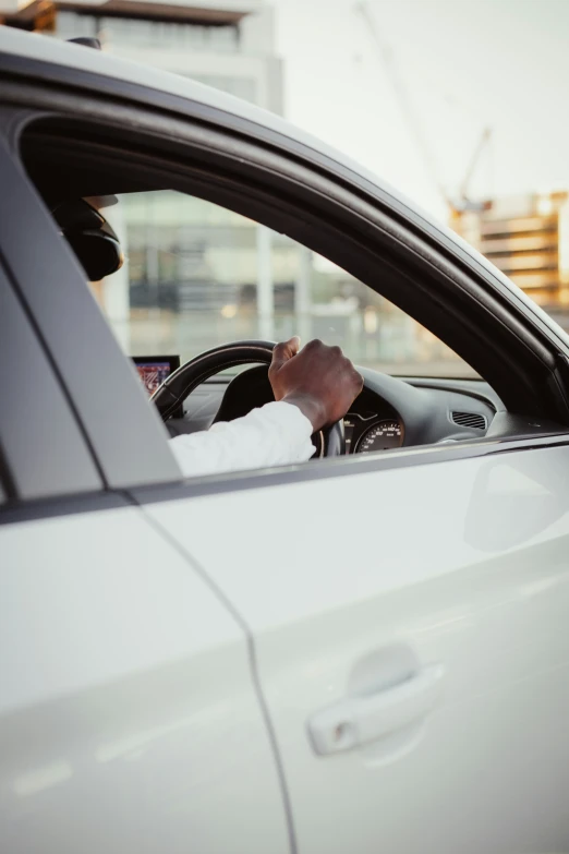 a man driving his car and talking on a phone