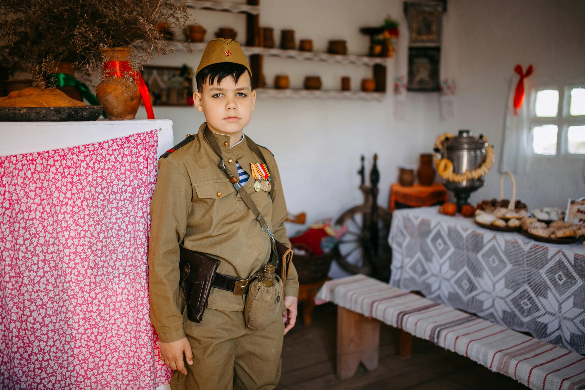 a  dressed in an army uniform and a table