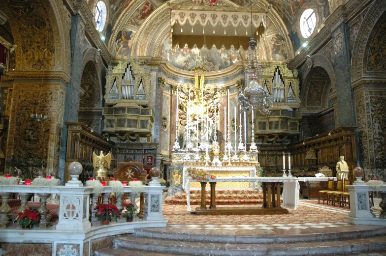 a white and gold alter in a very fancy building