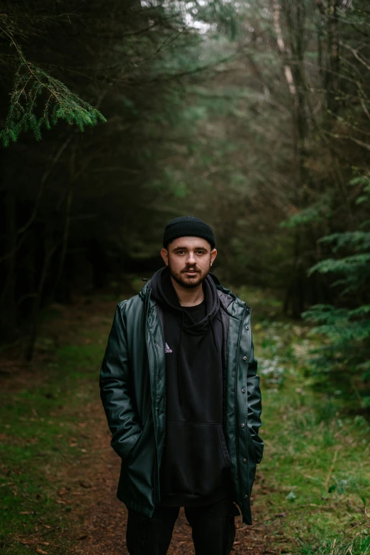 a man in the woods with trees in the background