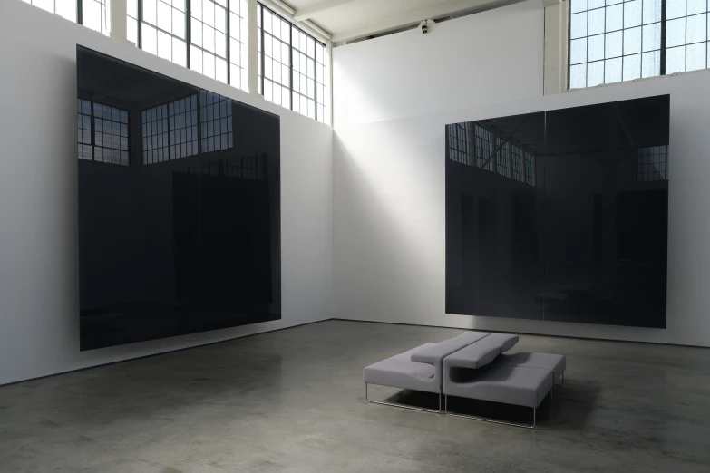 a bench sits in a room with a skylight