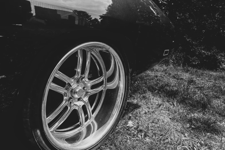 a car tire, parked in the grass