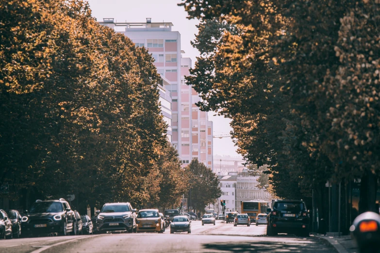 several cars on a city street next to tall buildings