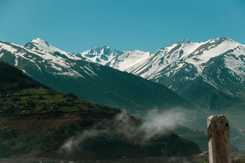 a large snowy mountain towering over a valley