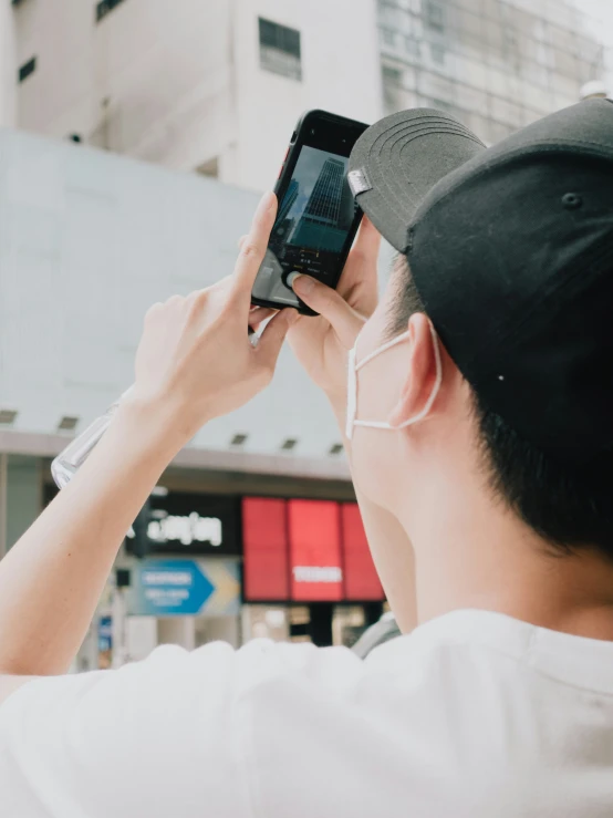 someone wearing glasses while looking at the phone