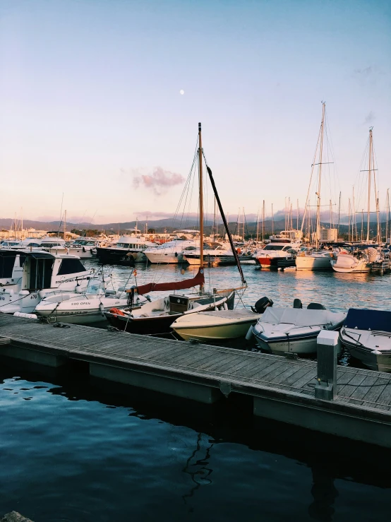 a marina full of ships and boats near a pier