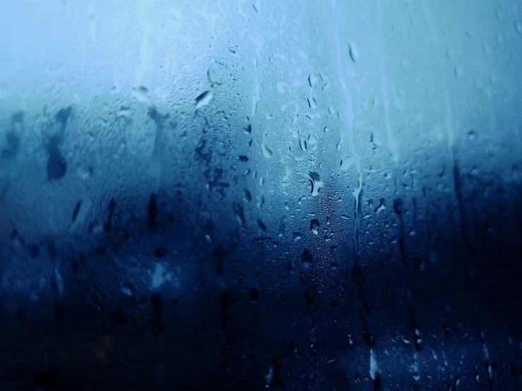 a blue glass textured with water drops