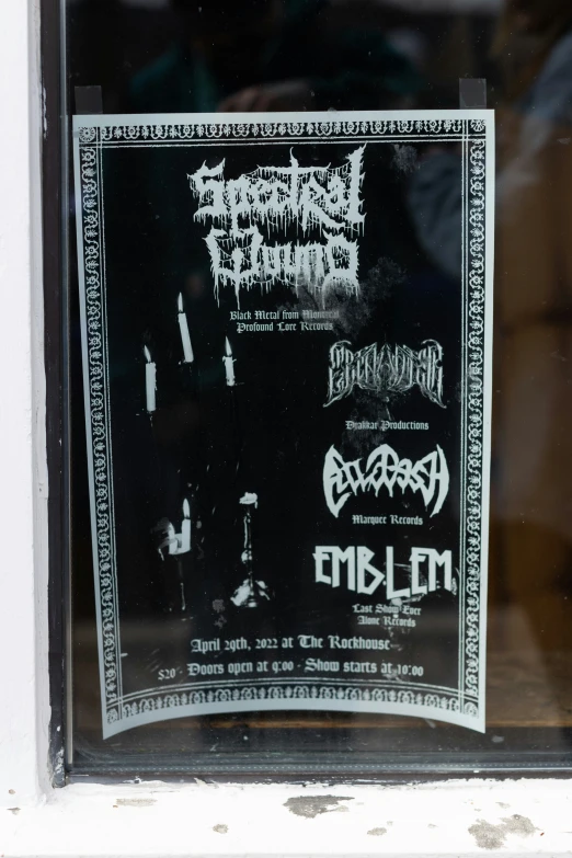 the front of a shop window with posters for extreme metal