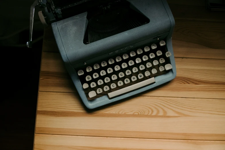 an old - style grey typewriter with no keyboard on the table