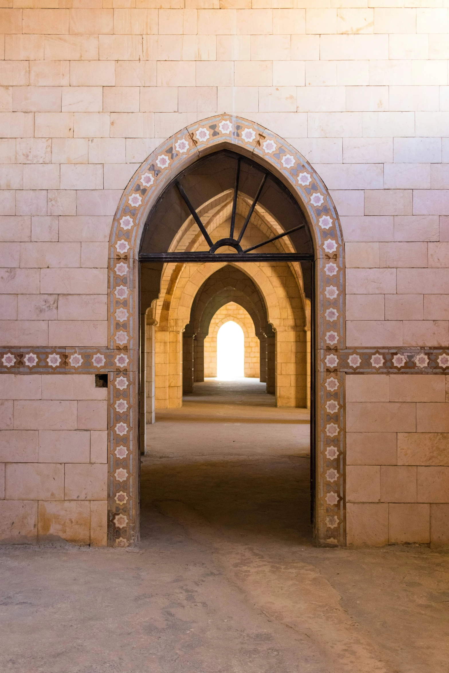 a building with a walkway through it in front of a white wall