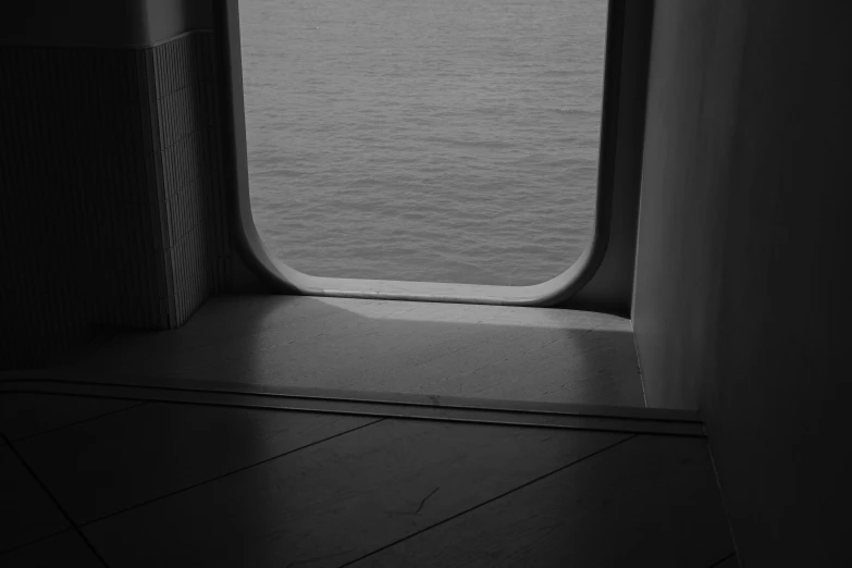 an open door of a ship showing the ocean